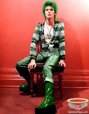 david bowie in glittering green pants and cardigan with green grunge boots and dyed green hair