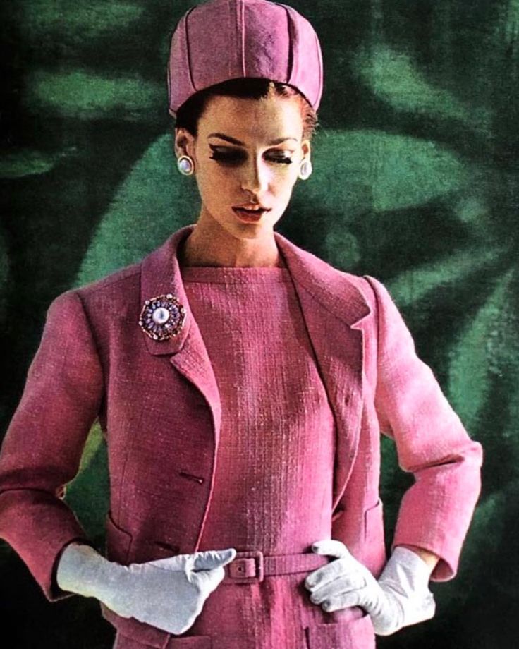 lady wearing 60's pink shift dress with matching blazar white gloves and a pink pill box hat