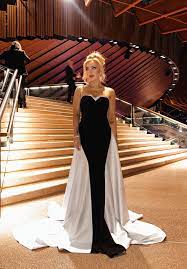 Blonde lady on the steps of Sydney Opera House in a black and white formal strapless dress