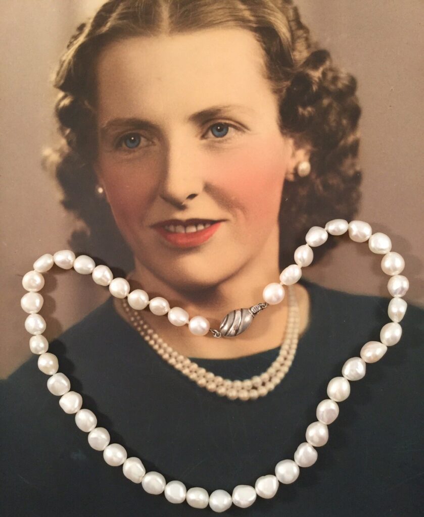 1940s vintage pearl necklace with vintage image of lady in background