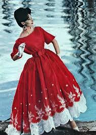 1960's cinched waist boatneck dress with flowing skirt and trimmed in white applique on the bottom